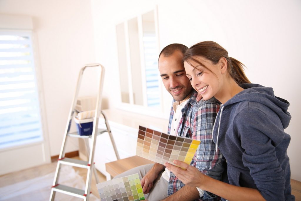 Couple choosing a new house paint color