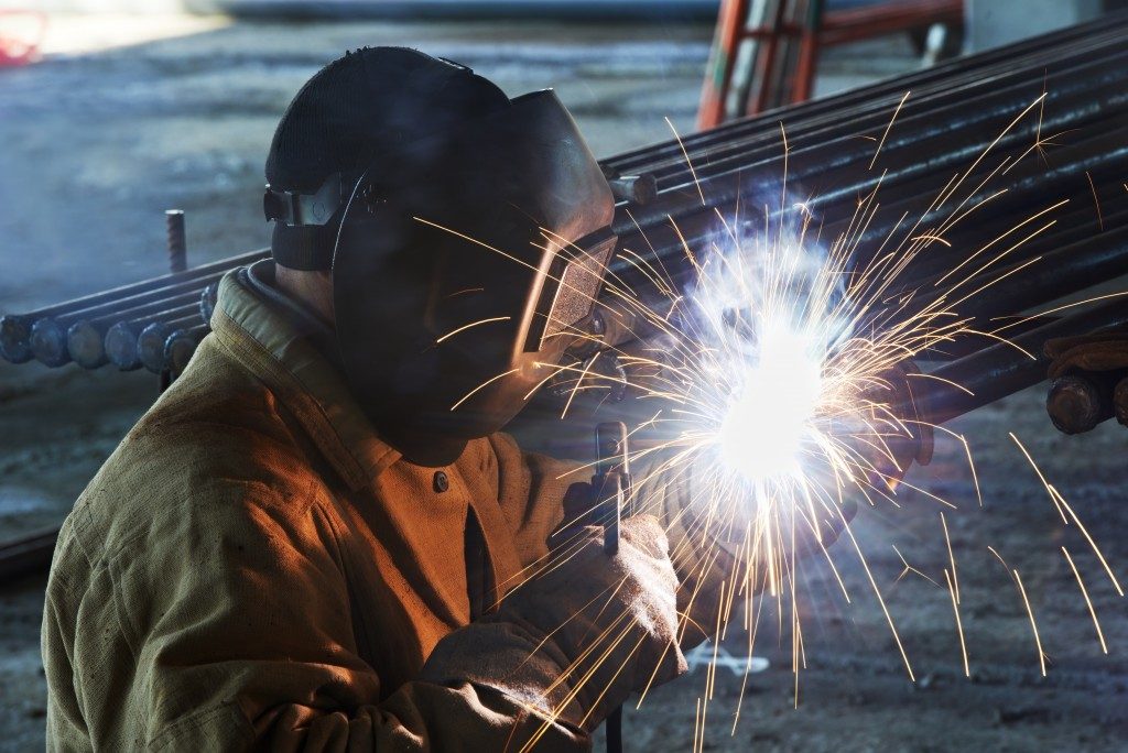 Worker fabricating steel
