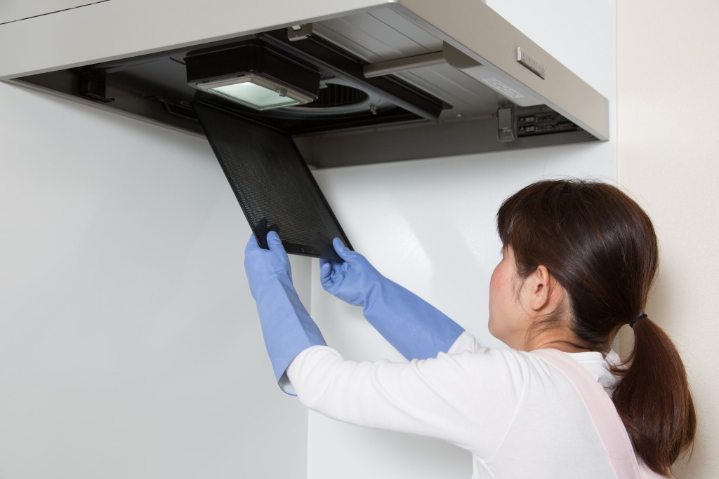 Woman cleaning the AC filter