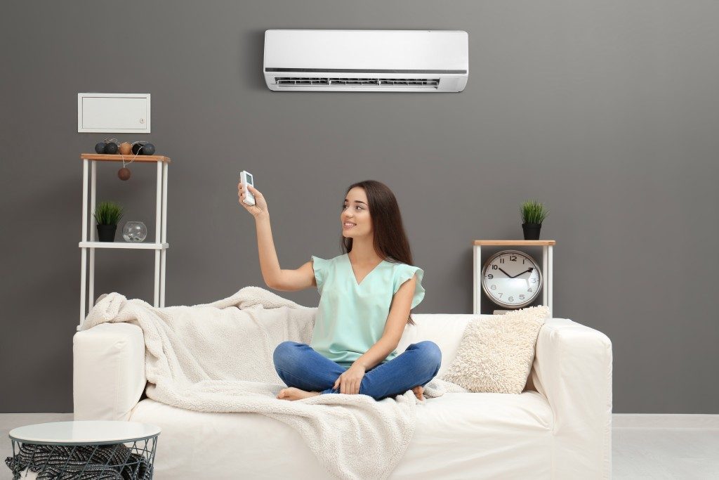 Woman using airconditioning home
