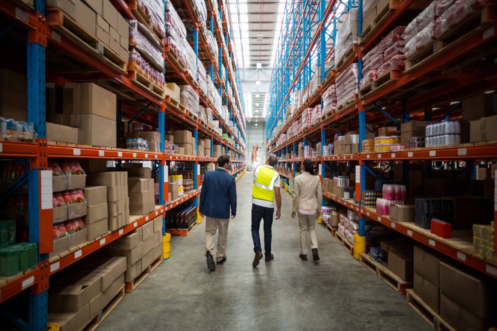 Team discussing while walking in a warehouse