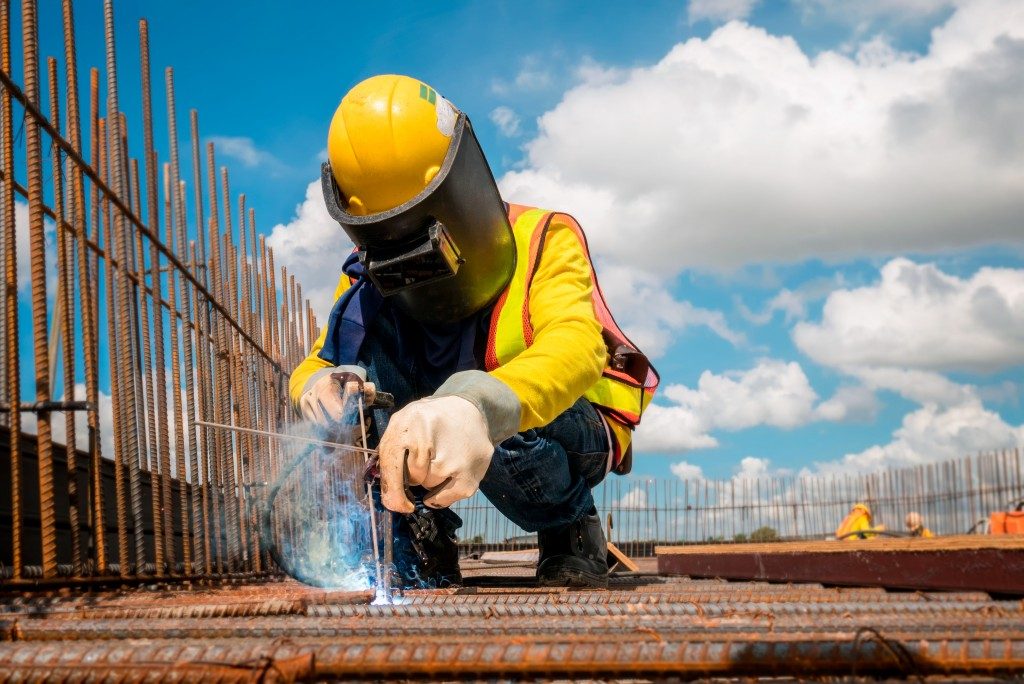 man wearing helmet doing construction