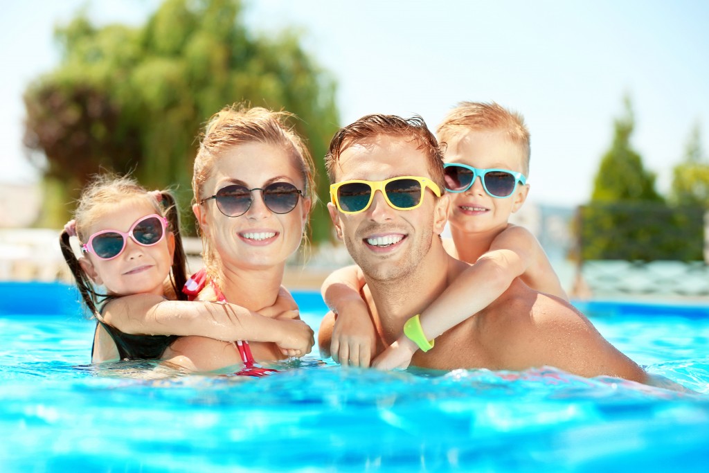 family swimming in the pool