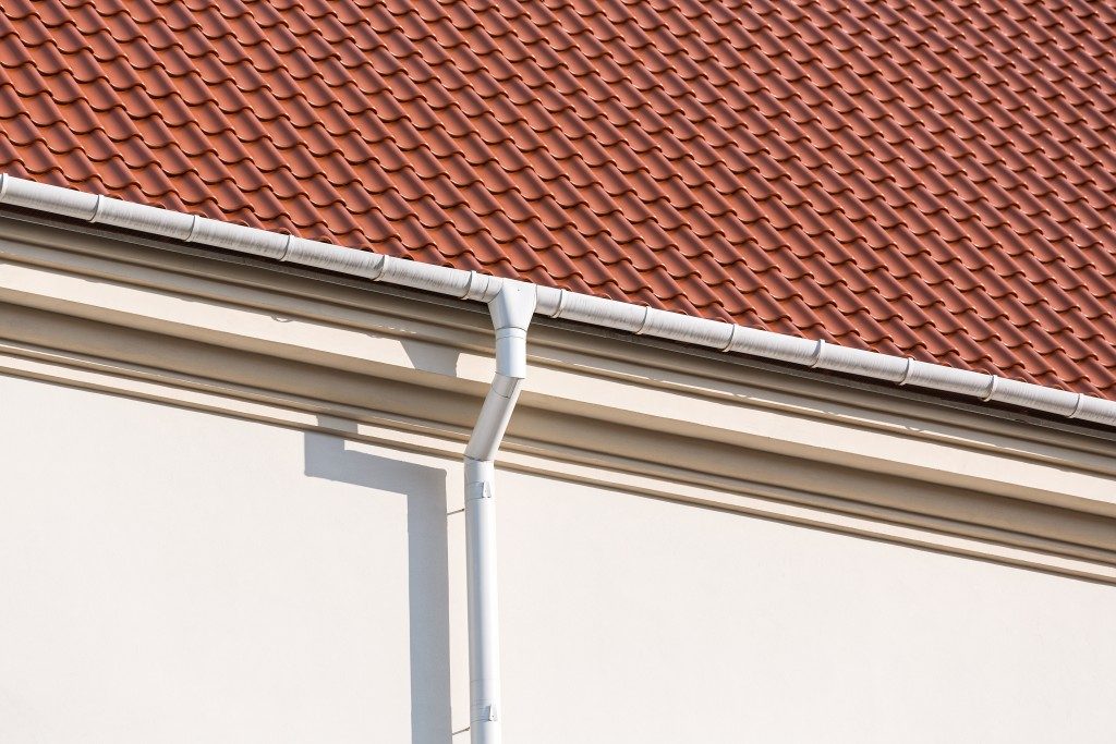 Rain gutter and downspout on the wall of a house