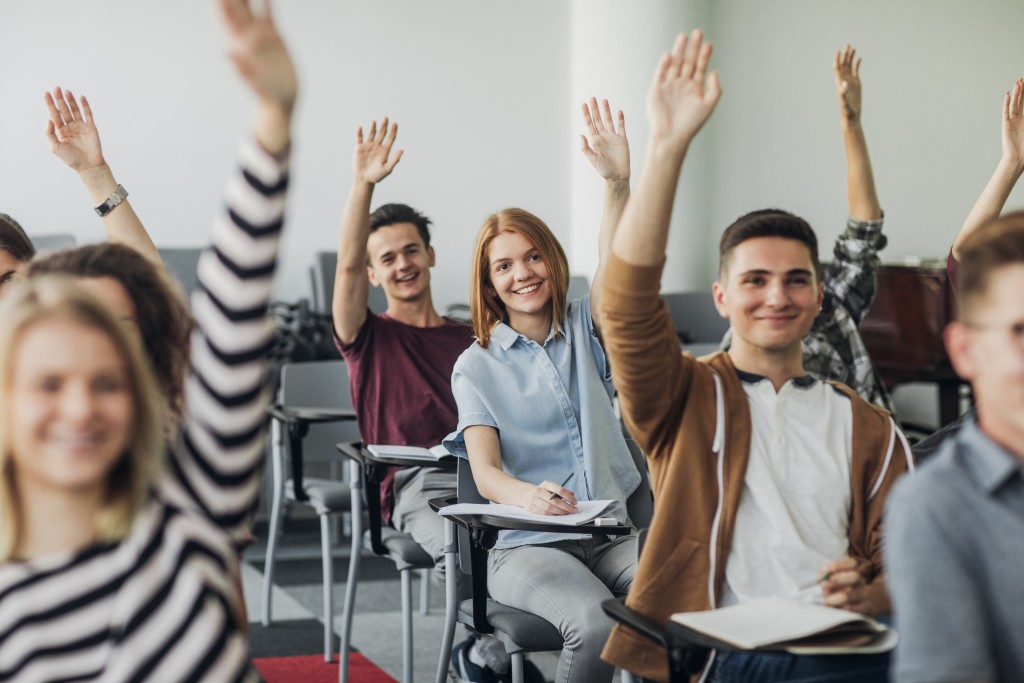 students raising their hands