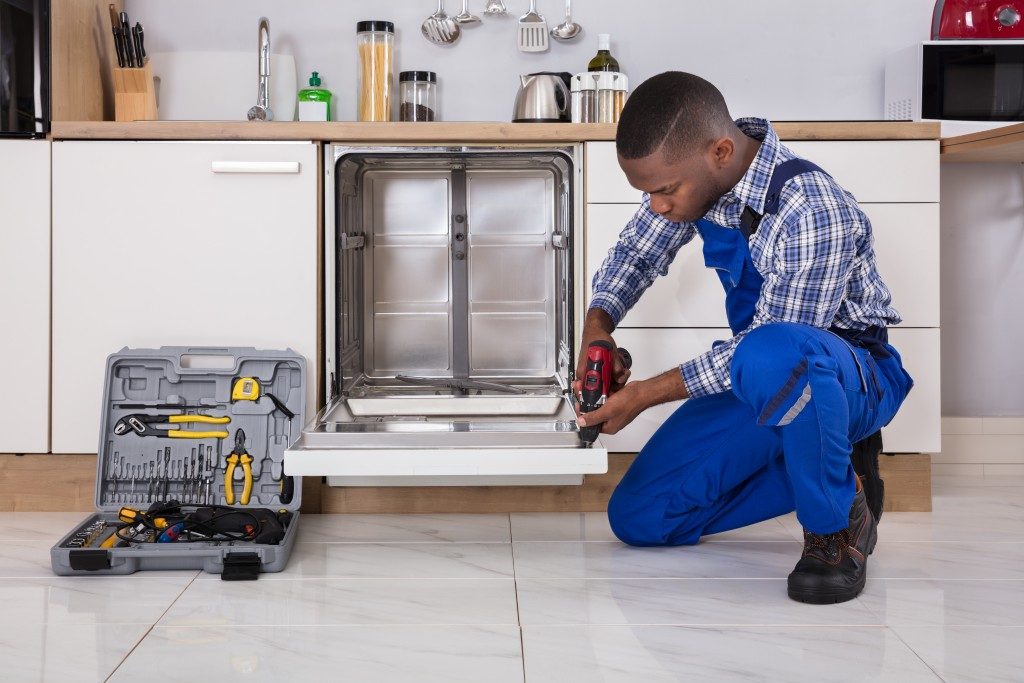 man fixing dishwasher