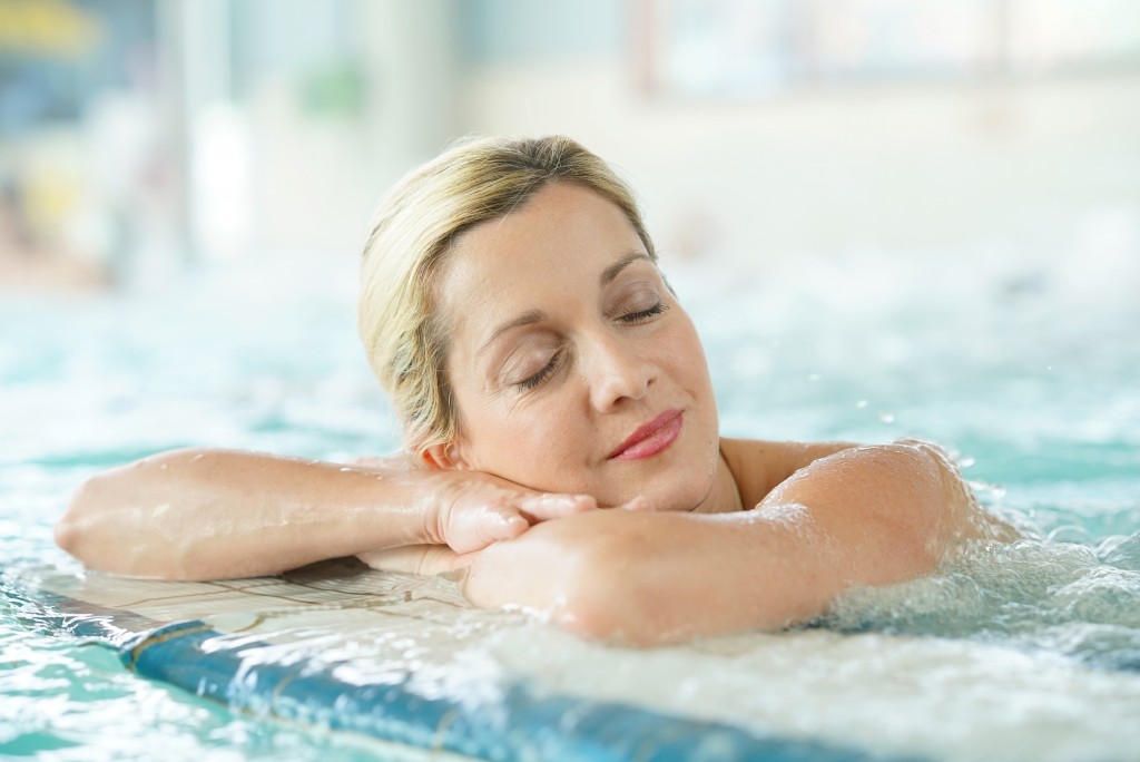 woman relaxing by the pool