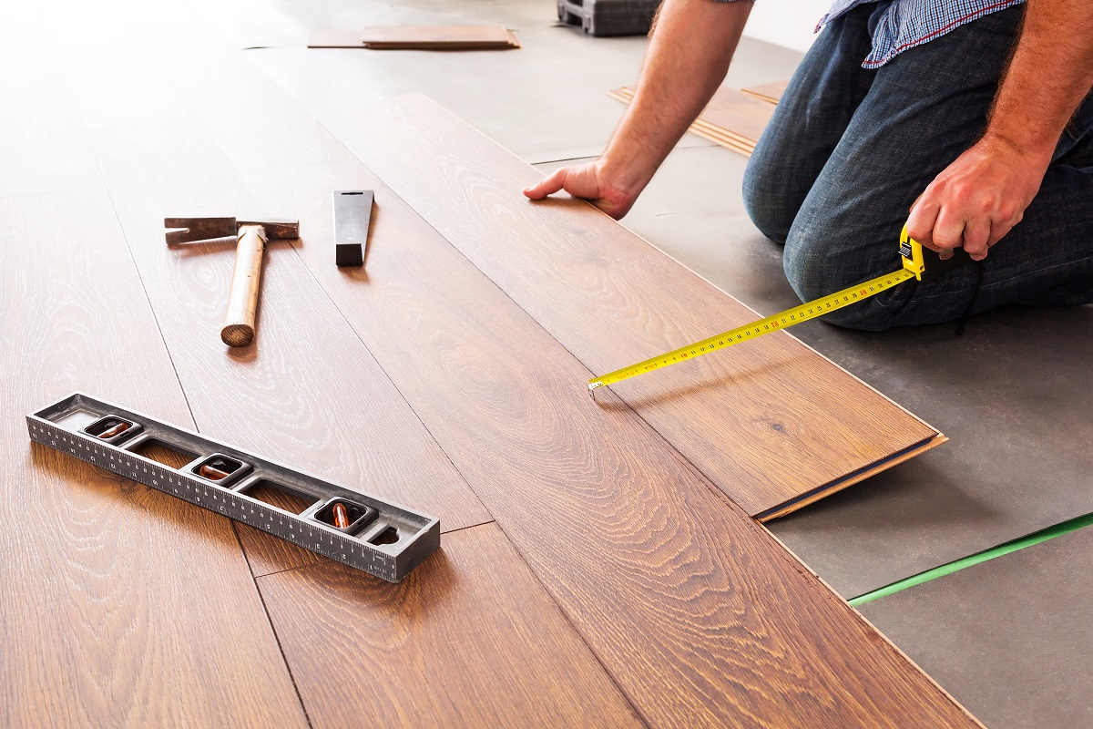 man installing hardwood flooring