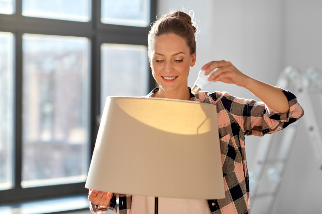 a woman holding a lamp